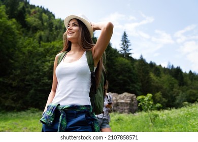 Happy young woman hiker hiking portrait with backpack. Fresh and healthy lifestyle.