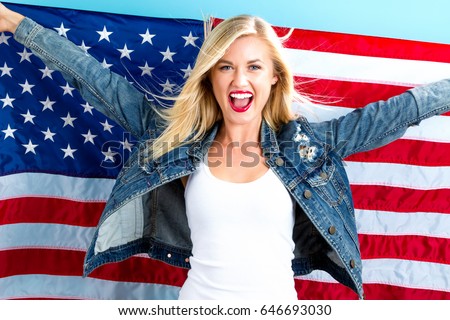 Happy young woman holding American flag