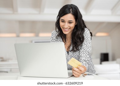 Happy Young Woman Holding A Credit Card And Shopping Online At Home. Beautiful Girl Using Laptop To Shop Online With Creditcard. Smiling Woman Using Laptop And Credit Card For Online Payment.