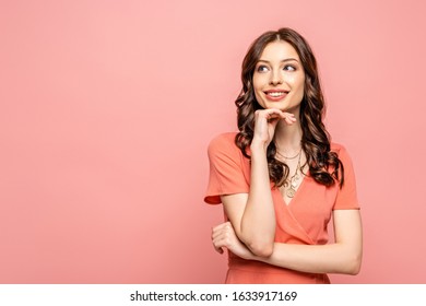 happy young woman holding hand near face while looking away isolated on pink - Shutterstock ID 1633917169