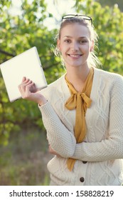 Happy Young Woman Holding An Ipad Outdoors