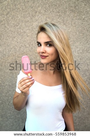 Image, Stock Photo Young and blonde woman holding a strawberry ice cream