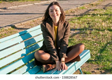 Happy young woman laughing outside in the sun