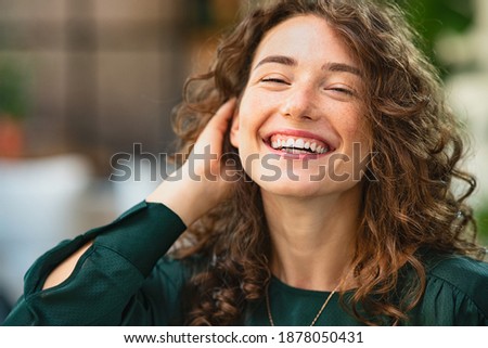 Similar – Close portrait of a young smiling woman with dimples in front of a white wall