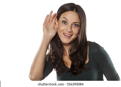 Happy Young Woman Listens With Her Hand Behind Her Ear