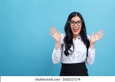 Happy Young Woman Making A Yay Gesture On A Blue Background