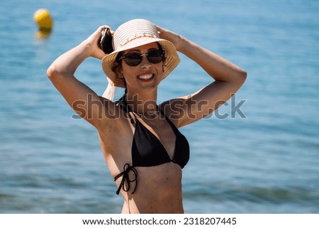 happy young woman with mobile phone on the beach