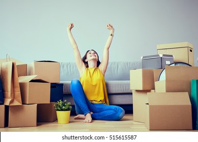 Happy young woman moving to new home - having fun