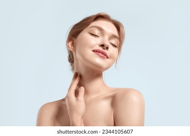 Happy young woman with natural beauty, and glowing light skin closed her eyes with pleasure - Powered by Shutterstock