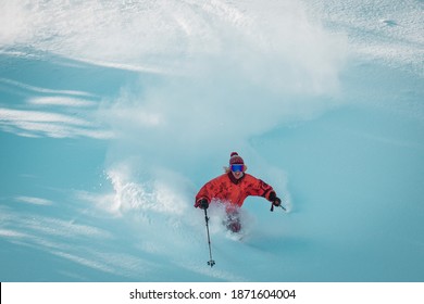 Happy Young Woman In Old School Orange Jacket Is Free Skiing In Fresh Winter Powder Of Trans-Ili Alatau Mountains In Kazakhstan