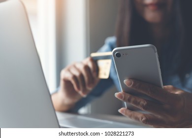 Happy Young Woman Online Shopping By Credit Card Payment On Mobile Smart Phone And Laptop Computer, Internet Banking, Mobile Banking, E Commerce, E Business, Financial Technology Fintech Concept.