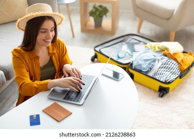 Joven feliz planeando viajes de vacaciones con laptop pc, leer blog de turismo en línea, reservar entradas o habitación de hotel en la web, prepararse para el viaje al extranjero en casa, espacio libre