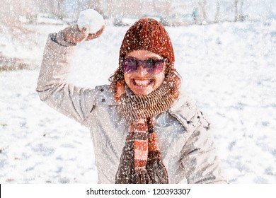 Happy Young Woman Playing Snowball Fight On The Snow  Day. Winter Concept.