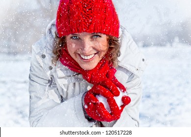 Happy Young Woman Playing Snowball Fight On The Snow Day. Winter Concept.