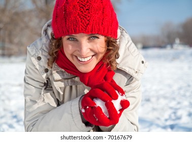 Happy Young Woman Playing Snowball Fight On The Snow Sunny Day