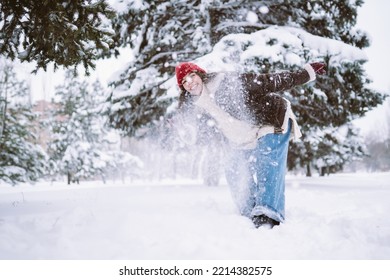 Happy Young Woman Plays With A Snow In Sunny Winter Day. Walk In Winter Forest. Christmas,  Holidays Concept.