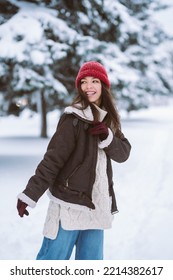 Happy Young Woman Plays With A Snow In Sunny Winter Day. Walk In Winter Forest. Christmas,  Holidays Concept.