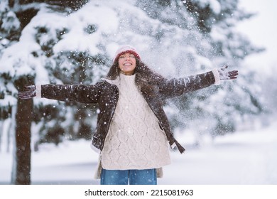 Happy Young Woman Plays With A Snow In Sunny Winter Day. Walk In Winter Forest. Christmas,  Holidays Concept.