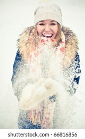 Happy Young Woman Plays With A Snow