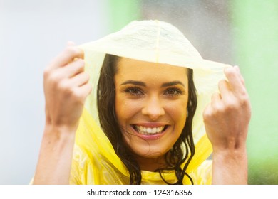 Happy Young Woman In Poncho In The Rain