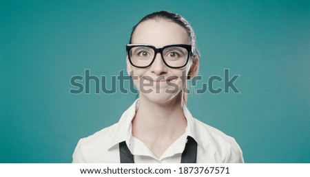 Happy young woman posing with glasses and making a funny smile