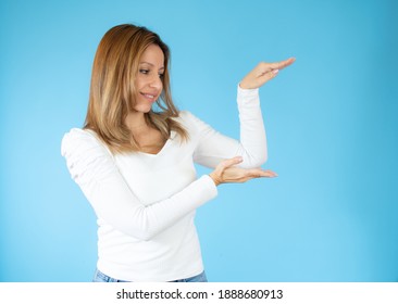 Happy Young Woman Presenting With Thumbs Up Over Blue Background