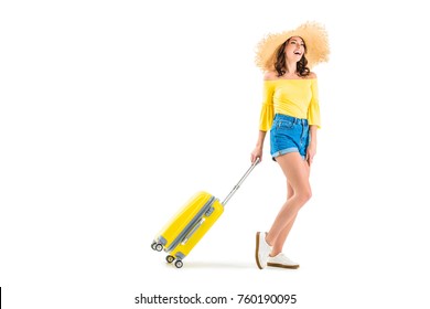 happy young woman pulling luggage isolated on white