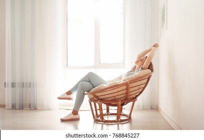 Happy young woman relaxing at home