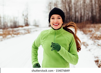 Happy Young Woman Running In Winter