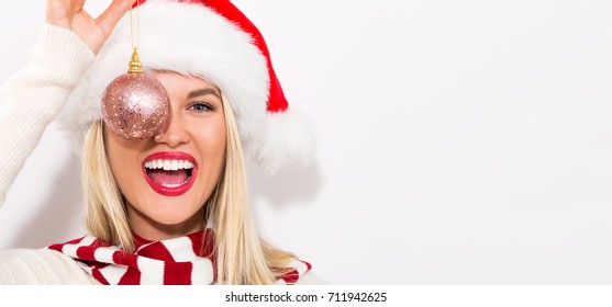 Happy young woman with Santa hat on a white background - Powered by Shutterstock