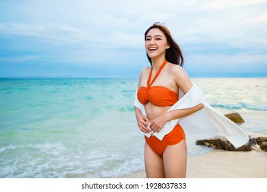 happy young woman in the sea beach at Koh MunNork Island, Rayong, Thailand
