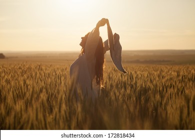 Happy Young Woman With A Shawl In Field