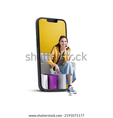 Happy young woman with shopping bags in a smartphone, online shopping and sales concept, isolated on white background