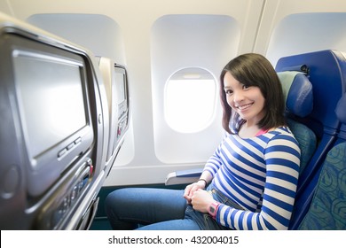 Happy Young Woman Is Sitting In The Airplane, Asian