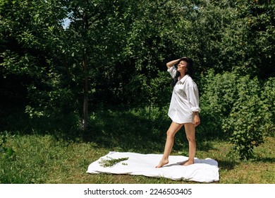  Happy Young Woman Sitting in the Grass Enjoining Nature. Carefree person resting in a countryside field experiencing mindfulness and calmness . High quality photo - Shutterstock ID 2246503405