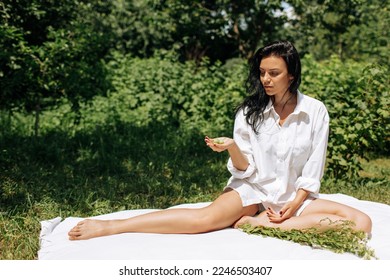  Happy Young Woman Sitting in the Grass Enjoining Nature. Carefree person resting in a countryside field experiencing mindfulness and calmness . High quality photo - Shutterstock ID 2246503407