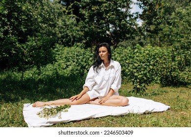  Happy Young Woman Sitting in the Grass Enjoining Nature. Carefree person resting in a countryside field experiencing mindfulness and calmness . High quality photo - Shutterstock ID 2246503409