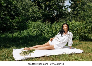  Happy Young Woman Sitting in the Grass Enjoining Nature. Carefree person resting in a countryside field experiencing mindfulness and calmness . High quality photo - Shutterstock ID 2246503411
