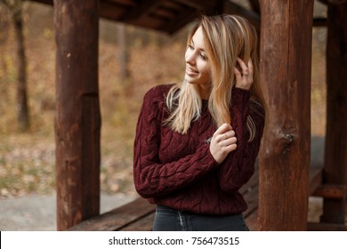 Happy Young Woman With A Smile In A Vintage Knitted Sweater Outdoors