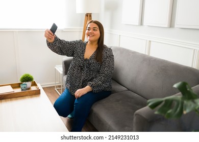 Happy Young Woman Smiling While Taking A Selfie With Her Smartphone. Gorgeous Obese Woman Promoting Body Positivity On Social Media