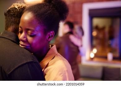 Happy Young Woman Standing Close To Her Girlfriend During Romantic Slow Dance Against Amorous Gay Couple Embracing One Another