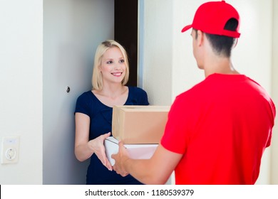 Happy Young Woman Standing At Door Get Her Order From Delivery Man In Red Uniform