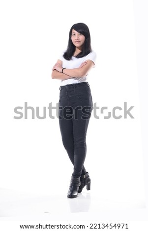 happy young woman standing full length posing on white background