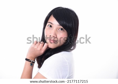 Happy young woman standing on white background

