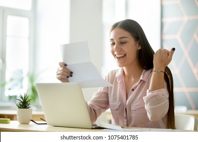 Happy young woman student or employee excited by reading good news in paper letter about new job, great deal, positive exam result, celebrating success or opportunity offered in written notification