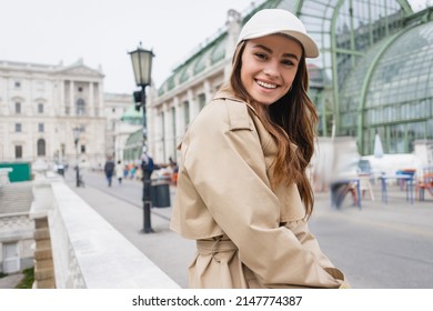 Happy Young Woman In Stylish Trench Coat And Baseball Cap