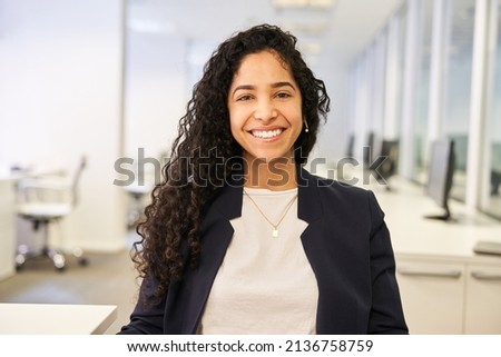 Happy young woman as a successful business start-up founder in the office