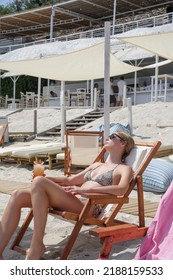 Happy Young Woman Sunbathing On The Beach Chair. Concept Of Relaxed Tropical Summer Vacation.