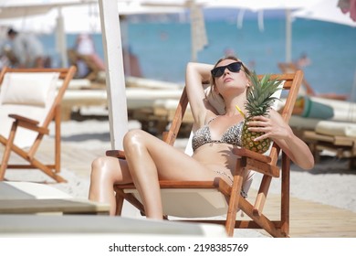 Happy Young Woman Sunbathing On The Beach Chair. Concept Of Relaxed Tropical Summer Vacation.