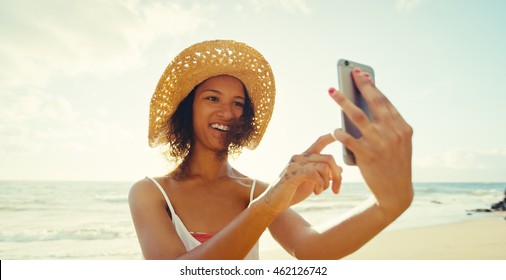 Happy Young Woman Taking Selfie On Mobile Phone At The Beach At Sunset